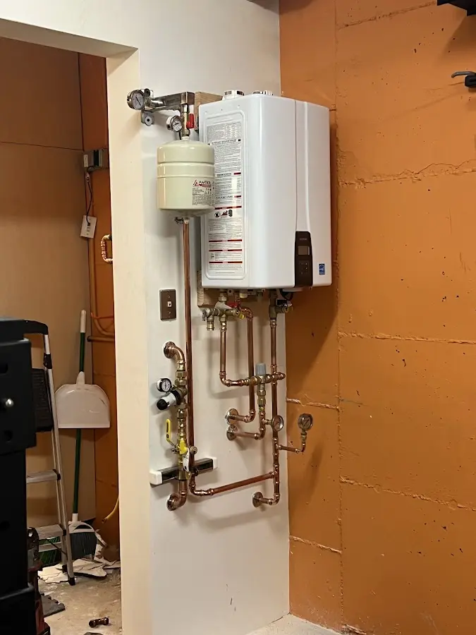 Plumbing technician inspecting water heater connections in Loma Linda